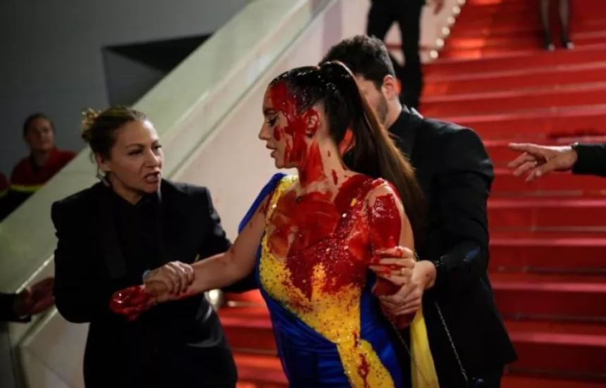 Activista se cubre de sangre falsa en la alfombra roja de Cannes