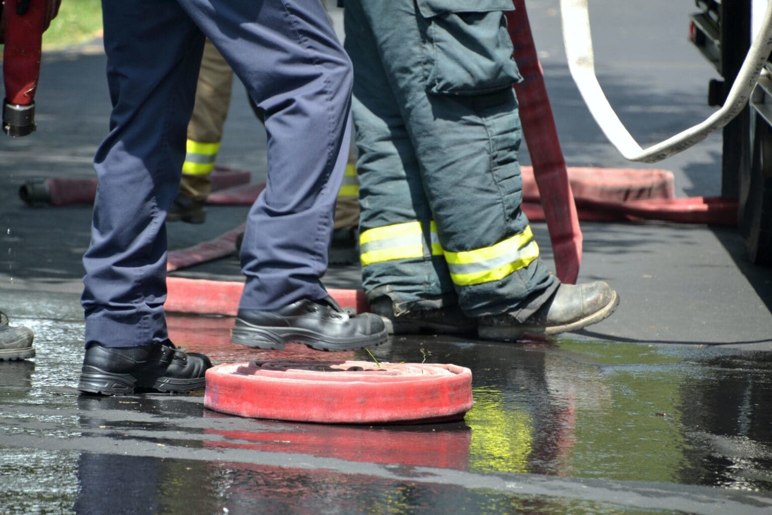 firemen and fire hoses on wet pavement after fight 2023 11 27 05 03 39 utc