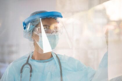 female doctor protective wear looking away